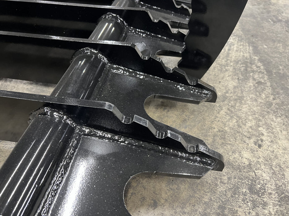 Compact tractor with tractor root grapple clearing fallen trees and logs after a storm.