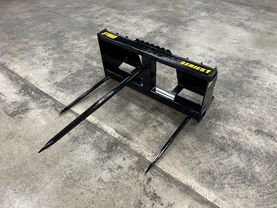 Stinger Series 1 bale spear attached to tractor loader moving heavy round bales – perfect tool for feeding and storage operations.