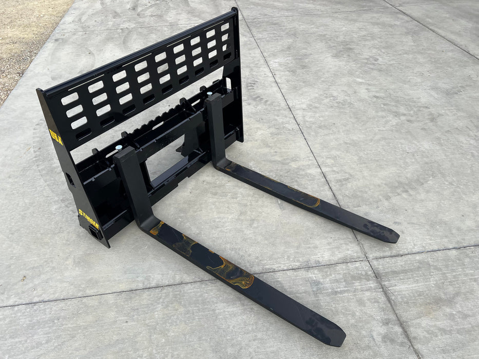 Heavy-duty skid steer pallet forks by Stinger moving hay bales – durable Class 2 design for versatile agricultural and industrial applications.