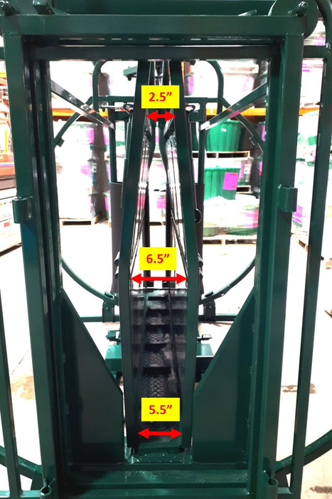 Operator rotating calf within Lakeland Calf Table to perform tagging and dehorning safely