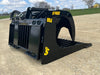 Heavy-duty skid steer grapple bucket by Stinger lifting mixed materials – strong and versatile tool for farms, construction sites, and property maintenance.