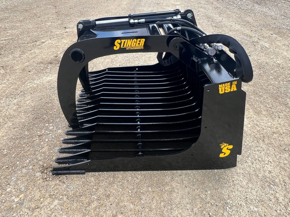 48-inch skid steer grapple bucket in action moving rocks – compact yet powerful design for precise material handling and land preparation.