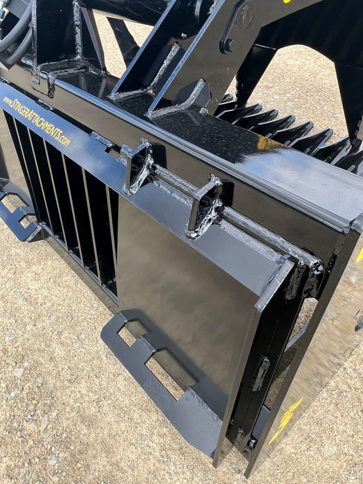 Front view of 48-inch heavy-duty skid steer grapple bucket holding rocks – reliable hydraulic design ensures strong, stable performance.