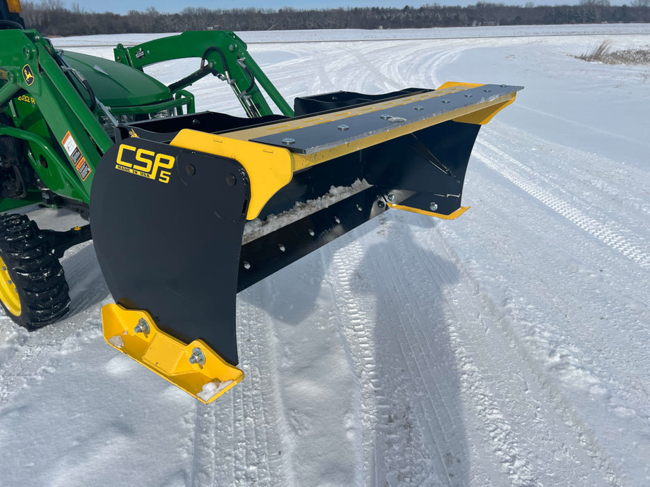 Stinger compact skid steer snow pusher clearing light and packed snow – versatile tool for residential and commercial use.