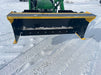 Side view of compact skid steer snow pusher handling deep snow – durable design provides maximum pushing efficiency and control.