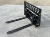 Stinger Class 2 skid steer pallet forks lifting wooden pallet – heavy-duty attachment built for reliable material handling and farm use.