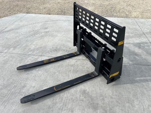 Stinger Class 2 skid steer pallet forks lifting wooden pallet – heavy-duty attachment built for reliable material handling and farm use.