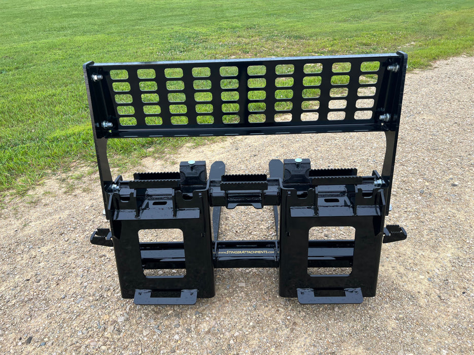Durable Stinger Class 3 skid steer pallet forks transporting concrete blocks – precision-engineered for power, safety, and stability.