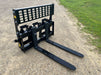 Front view of Stinger skid steer pallet forks lifting heavy materials – heavy-duty Class 3 model built for demanding lifting operations.