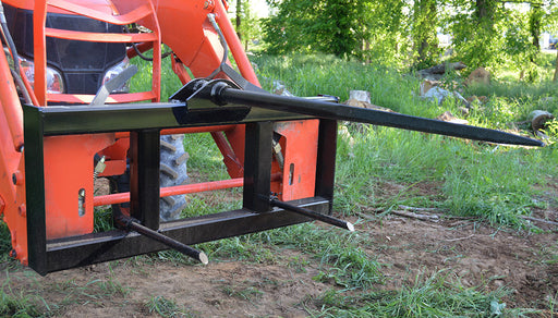 Loflin Skid Steer Hay Spear with quick attach mount, ideal for lifting and transporting large hay bales efficiently on the farm.