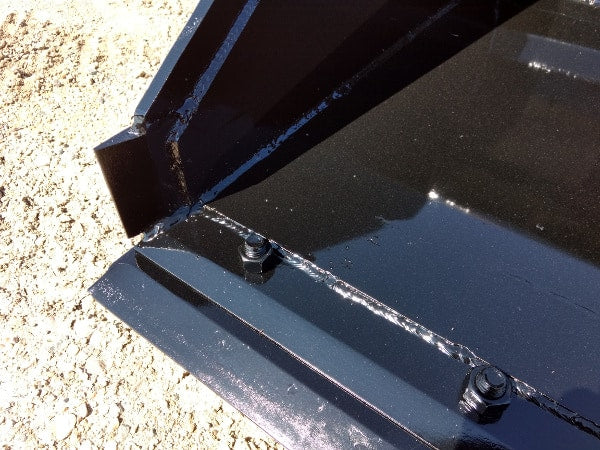 Stinger Series 3 skid steer material bucket performing grading work – durable construction ensures smooth and accurate results.