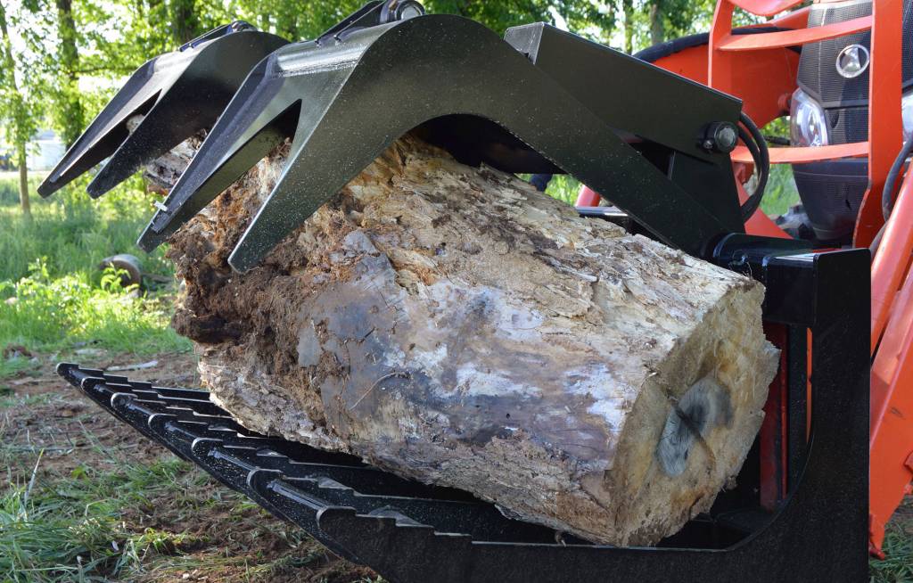 Loflin Medium Duty Skid Steer Root Grapple featuring dual hydraulic arms for efficient handling of roots, brush, and debris.