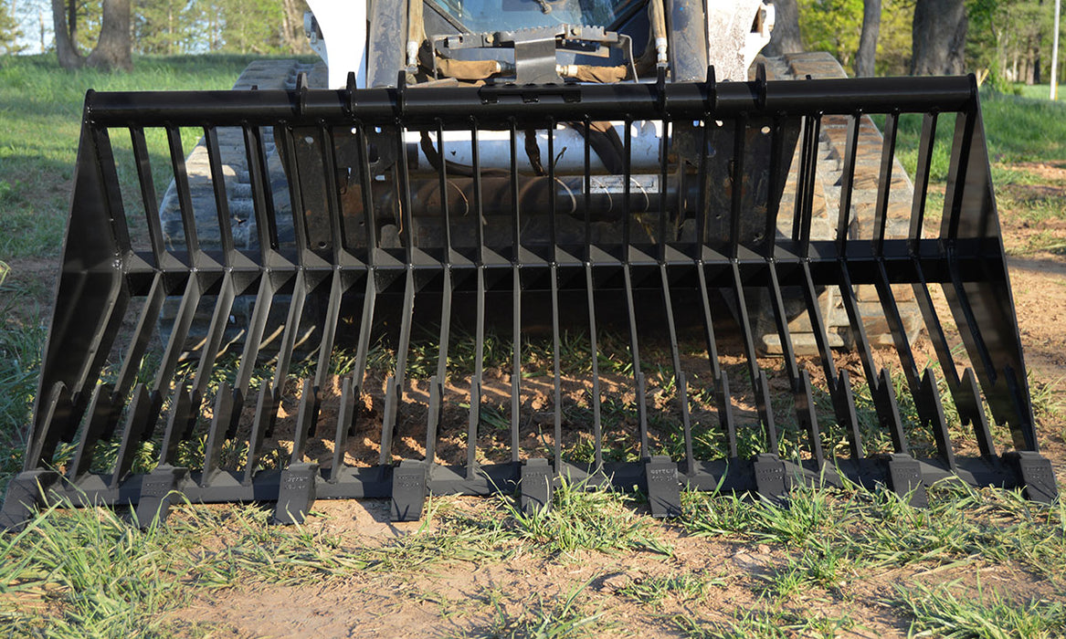 Loflin Old Style skid steer rock bucket sorting rocks and debris on a construction site – heavy-duty attachment designed for maximum durability and precision.