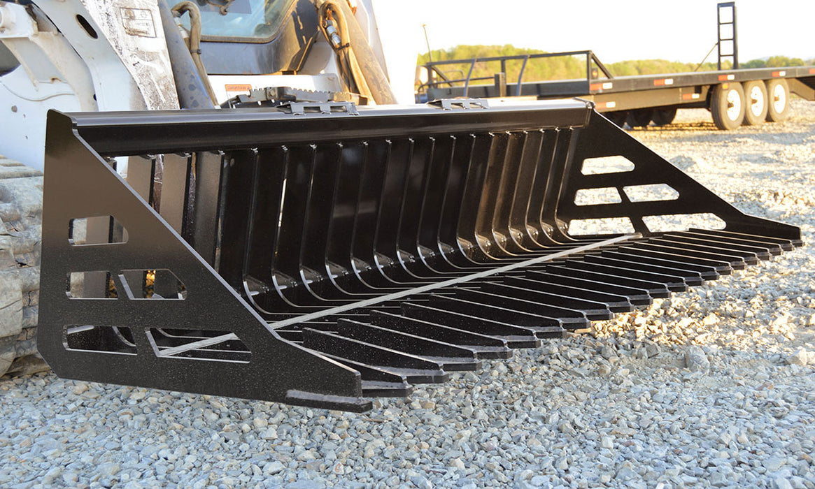 Loflin Fabrication skid steer rock bucket sorting rocks and debris on rugged terrain – heavy-duty design built for strength and long-lasting performance.