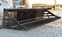 Loflin Fabrication skid steer rock bucket sorting rocks and debris on rugged terrain – heavy-duty design built for strength and long-lasting performance.