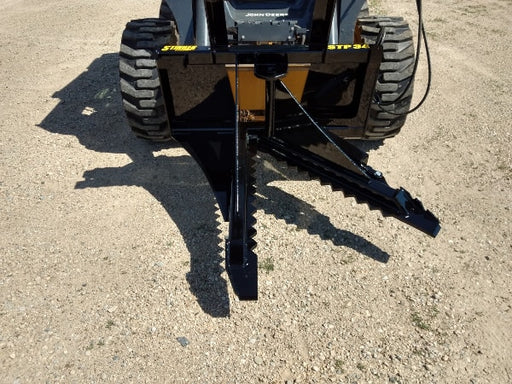 Heavy-duty skid steer tree puller gripping small tree trunks – durable attachment designed for fast and efficient tree and root removal.