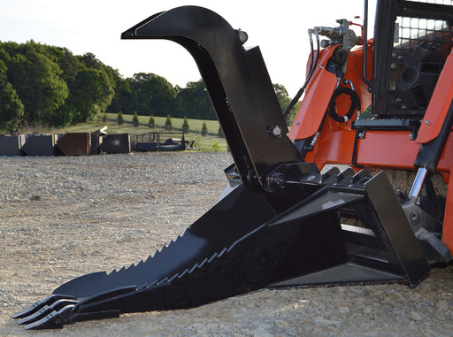 Loflin Fabrication skid steer stump bucket with hydraulic grapple removing stumps and roots – heavy-duty attachment built for efficient land clearing.