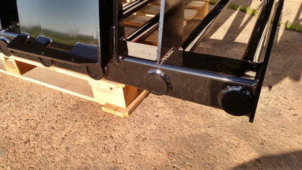 Manure tine skid steer grapple bucket by Stinger scooping organic debris – dependable design for long-term farm performance.