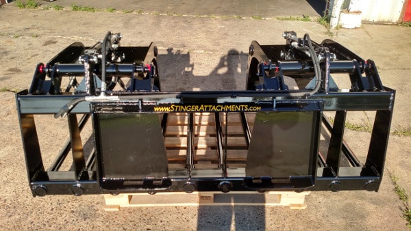 Stinger skid steer grapple bucket handling straw and manure – high-capacity design ideal for cleaning barns and feedlots.