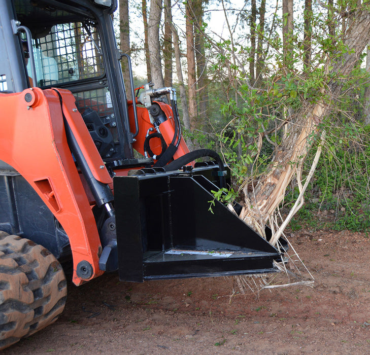 Loflin Fabrication skid steer tree puller gripping and removing small trees and brush – heavy-duty attachment built for land clearing and vegetation control.