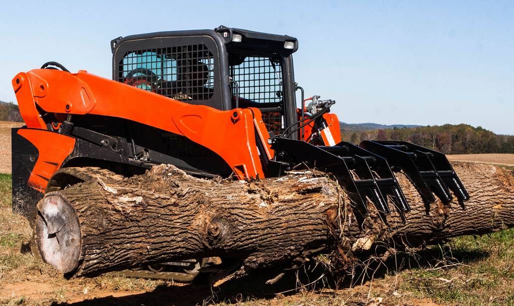 Loflin Fabrication vertical skid steer root grapple lifting logs and brush – heavy-duty attachment engineered for powerful land clearing and debris removal.